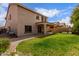 Expansive backyard with a covered patio, well-kept lawn, and privacy fence at 11106 E Serafina Ave, Mesa, AZ 85212