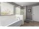 Relaxing bathroom showcasing a soaking tub, separate shower, and neutral color palette at 11106 E Serafina Ave, Mesa, AZ 85212