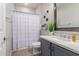 Bright bathroom boasts a stylish vanity, elegant mirror, and shower with a modern shower curtain at 11106 E Serafina Ave, Mesa, AZ 85212