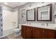 Neutral-toned bathroom features a dual sink vanity and a shower-over-tub combination at 11106 E Serafina Ave, Mesa, AZ 85212