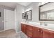 Bright bathroom featuring a double sink vanity with ample storage and framed mirrors at 11106 E Serafina Ave, Mesa, AZ 85212