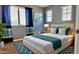 Cozy bedroom with blue walls, a queen-sized bed, and warm lighting at 11106 E Serafina Ave, Mesa, AZ 85212