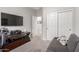 Comfortable bedroom with a cozy seating area, ample closet space, and neutral decor for a relaxing retreat at 11106 E Serafina Ave, Mesa, AZ 85212