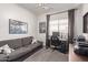 Cozy bedroom featuring a comfortable sofa, desk, and ample space at 11106 E Serafina Ave, Mesa, AZ 85212