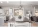 Open dining area with a large table, stylish lighting, and sliding glass doors to a beautiful backyard at 11106 E Serafina Ave, Mesa, AZ 85212