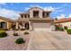 Traditional two-story home features a two-car garage, well-kept yard, and inviting front entrance at 11106 E Serafina Ave, Mesa, AZ 85212