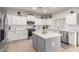 Bright kitchen with white cabinets, stainless steel appliances, granite counters, and a gray center island at 11106 E Serafina Ave, Mesa, AZ 85212