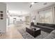 Open floor plan featuring a living room, dining area and kitchen with a gray couch and large windows at 11106 E Serafina Ave, Mesa, AZ 85212