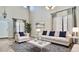 Bright living room features stylish decor, a modern sofa, and a comfortable armchair at 11106 E Serafina Ave, Mesa, AZ 85212
