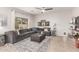 Comfortable living room featuring a large gray sectional, area rug, and stylish décor at 11106 E Serafina Ave, Mesa, AZ 85212