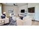 Stylish living room featuring white furniture, a modern TV, and floating shelves at 11106 E Serafina Ave, Mesa, AZ 85212
