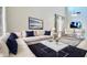 Modern living room boasting a plush sectional sofa, sleek decor, and ample natural light at 11106 E Serafina Ave, Mesa, AZ 85212