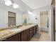 Bathroom features a double sink vanity with granite counters, neutral paint, and a separated tub/shower at 11260 N 92Nd St # 2025, Scottsdale, AZ 85260