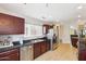 Well-lit kitchen features stainless steel appliances, dark cabinets, tile backsplash, and tiled floors at 11260 N 92Nd St # 2025, Scottsdale, AZ 85260