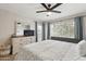 Spacious main bedroom featuring a large window for natural light and a modern ceiling fan at 11260 N 92Nd St # 2025, Scottsdale, AZ 85260