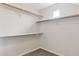 A simple, walk-in closet space featuring carpet, a small window, and minimalist organization at 11260 N 92Nd St # 2025, Scottsdale, AZ 85260