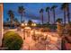 A wonderful back patio featuring a fire place, a dining table and a stunning view of the golf course at 13221 W Rincon Dr, Sun City West, AZ 85375