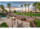 An inviting back patio with a fireplace, a dining table and a lush green golf course view at 13221 W Rincon Dr, Sun City West, AZ 85375