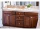 Spacious bathroom vanity with warm wood cabinets, stylish tile, and ample storage, enhancing the bathroom's appeal at 13221 W Rincon Dr, Sun City West, AZ 85375