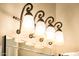 Elegant bathroom lighting fixture above mirror providing ambient illumination and decorative flair at 13221 W Rincon Dr, Sun City West, AZ 85375