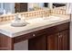Bathroom vanity with a sink, faucet, decor, mirror, and patterned tile, for a comfortable and visually pleasing space at 13221 W Rincon Dr, Sun City West, AZ 85375