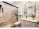 Bright bathroom featuring a walk-in shower, white cabinets, and light countertops at 13221 W Rincon Dr, Sun City West, AZ 85375