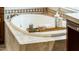 Elegant soaking bathtub with tile surround and accessories, enhancing relaxation in this stylish bathroom at 13221 W Rincon Dr, Sun City West, AZ 85375
