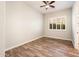 Neutral bedroom featuring wood-look floors and a window with plantation shutters at 13221 W Rincon Dr, Sun City West, AZ 85375