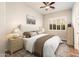 Cozy bedroom with a neutral color palette and a large window with plantation shutters at 13221 W Rincon Dr, Sun City West, AZ 85375