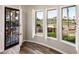 View from a bedroom with plantation shutters overlooking a pool, golf course, and outdoor kitchen at 13221 W Rincon Dr, Sun City West, AZ 85375