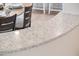 Countertop with a gray and white design, chairs and table visible at 13221 W Rincon Dr, Sun City West, AZ 85375