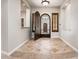 Elegant foyer with arched doorway and tile flooring and decorative mosaic at 13221 W Rincon Dr, Sun City West, AZ 85375