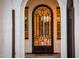 Inviting front door with an ornate wrought iron security screen and sidelight windows at 13221 W Rincon Dr, Sun City West, AZ 85375