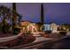 Charming front exterior featuring well-manicured landscaping and inviting entrance at twilight at 13221 W Rincon Dr, Sun City West, AZ 85375