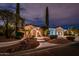 Charming front exterior featuring well-manicured landscaping and inviting entrance at twilight at 13221 W Rincon Dr, Sun City West, AZ 85375