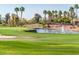 Picturesque golf course view featuring a water hazard with fountain and lush green grass at 13221 W Rincon Dr, Sun City West, AZ 85375