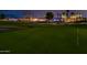 Picturesque golf course at twilight with manicured greens and community homes in the distance at 13221 W Rincon Dr, Sun City West, AZ 85375