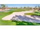 Beautiful shot of golf course featuring the sand bunker, manicured grass, and blue skies at 13221 W Rincon Dr, Sun City West, AZ 85375