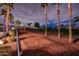 Scenic view of the golf course featuring lush greenery, palm trees, and community homes at 13221 W Rincon Dr, Sun City West, AZ 85375