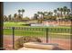 Scenic golf course view with water feature, lush greenery, and palm trees at 13221 W Rincon Dr, Sun City West, AZ 85375
