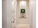 Hallway featuring decorative niche with a green decorative square and neutral paint at 13221 W Rincon Dr, Sun City West, AZ 85375