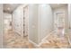 Hallway with tile flooring leads to other rooms with white door frames and baseboards at 13221 W Rincon Dr, Sun City West, AZ 85375