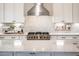 Spacious kitchen with stainless steel range, granite countertops, and white cabinets at 13221 W Rincon Dr, Sun City West, AZ 85375