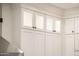 Bright kitchen featuring white cabinets with glass doors and modern hardware at 13221 W Rincon Dr, Sun City West, AZ 85375