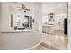 View of the kitchen with white cabinetry and marble countertops at 13221 W Rincon Dr, Sun City West, AZ 85375
