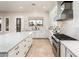 Modern kitchen boasts stainless appliances, granite counters, and ample cabinet space at 13221 W Rincon Dr, Sun City West, AZ 85375