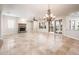 Spacious living room with tile floors, a fireplace, and ample natural light from the sliding doors at 13221 W Rincon Dr, Sun City West, AZ 85375