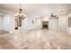 Open living space featuring tile flooring, a fireplace, and chandelier lighting at 13221 W Rincon Dr, Sun City West, AZ 85375