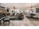 Open concept living room featuring a stone fireplace, neutral furniture, and large windows for plenty of natural light at 13221 W Rincon Dr, Sun City West, AZ 85375