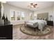 Relaxing main bedroom with a seating bench and large windows overlooking the yard at 13221 W Rincon Dr, Sun City West, AZ 85375
